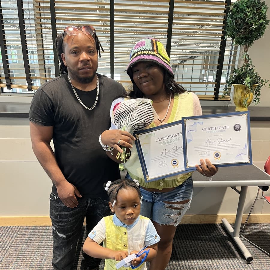 A Brilliantaires graduate holding her certificate