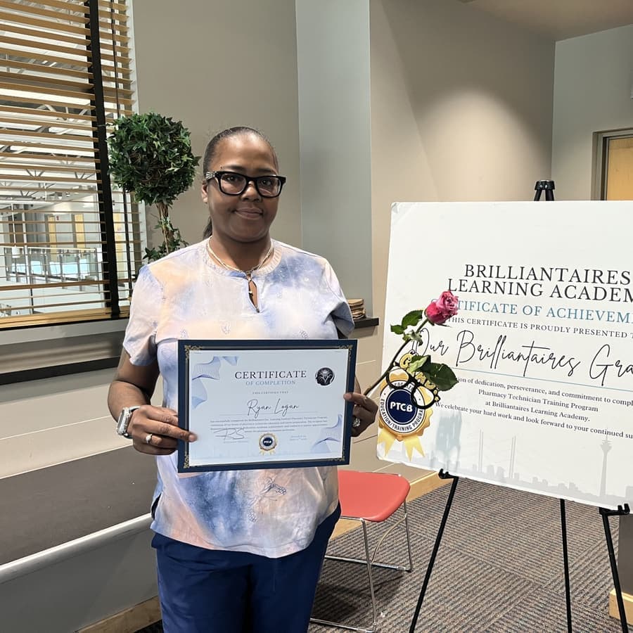A Brilliantaires graduate holding her certificate